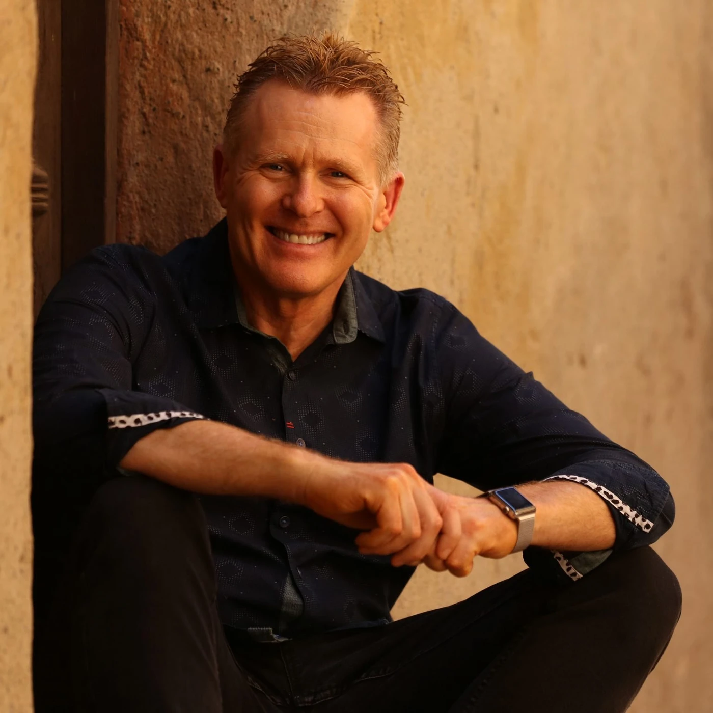 Dr. Robert Puff smiling, seated in a warm, sunlit setting